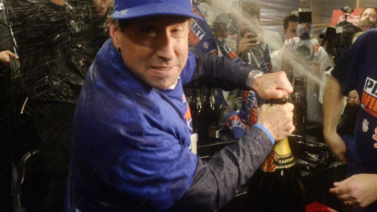 New York Mets owner Jeff Wilpon pops a huge bottle of champagne as the Mets celebrate in the clubhouse after beating the Chicago Cubs in the NLCS at Wrigley Field on Wednesday, Oct. 21, 2015.