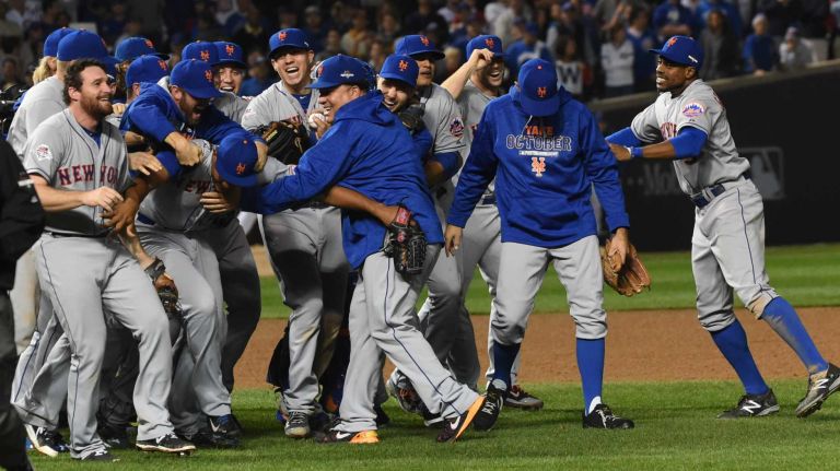 The New York Mets celebrate their NLCS victory over the Chicago Cubs at Wrigley Field on Wednesday, Oct. 21, 2015.
