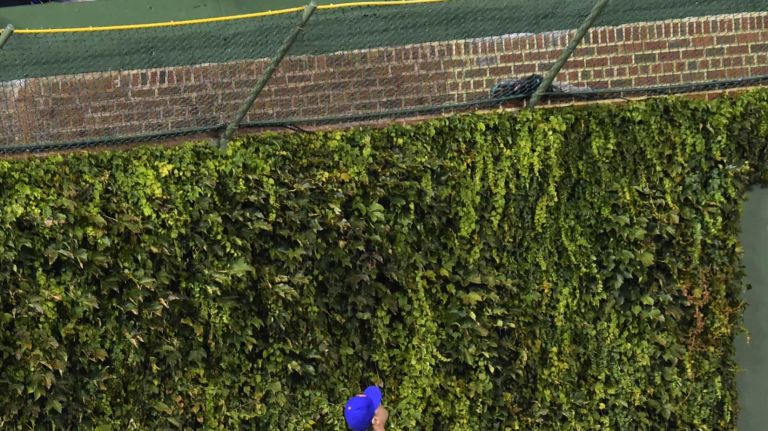 NLCS Game 3: Mets vs. Cubs 59 New York Mets leftfielder Michael Conforto (30) can only watch as Chicago Cubs leftfielder Kyle Schwarber (12) hits a first-inning home run during Game 3 of the NLCS against the Chicago Cubs at Wrigley Field on Tuesday, Oct. 20, 2015.