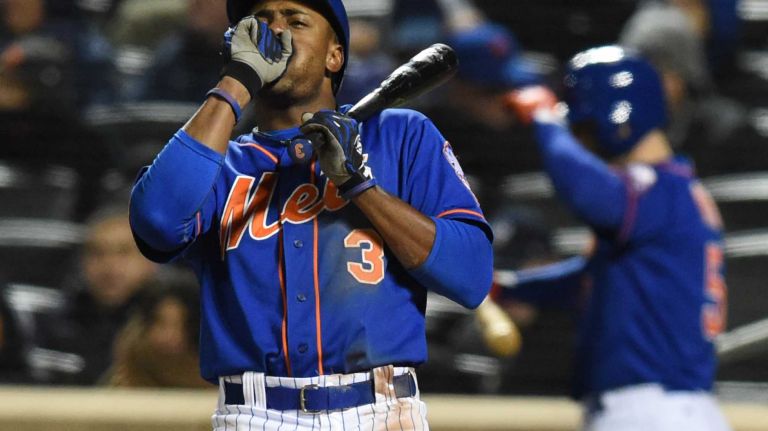 New York Mets right fielder Curtis Granderson (3) reacts to the weather during Game 2 of the NLCS against the Chicago Cubs at Citi Field on Sunday, Oct. 18, 2015.