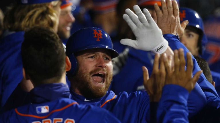 New York Mets second baseman Daniel Murphy (28) celebrates in dugout after his 2 run homerun in first inning during Game 2 of the NLCS against the Chicago Cubs at Citi Field on Sunday, Oct. 18, 2015.