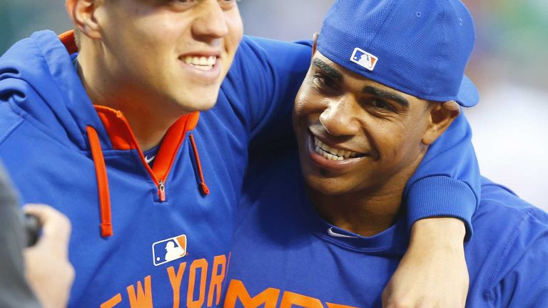 Yoenis Cespedes 15 Yoenis Cespedes #52 and Wilmer Flores #4 of the New York Mets celebrate after defeating the Washington Nationals at Citi Field on Sunday, Oct. 4, 2015.