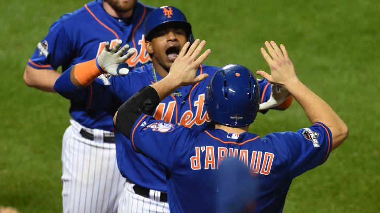 New York Mets centerfielder Yoenis Cespedes (52) high-fives teammate Travis d'Arnaud (7) after hitting a fourth-inning home run during Game 3 of the NLDS against the Los Angeles Dodgers on Monday, Oct. 12, 2015.
