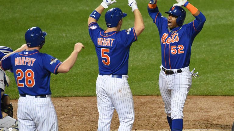New York Mets second baseman Daniel Murphy (28) and third baseman David Wright (5) wait at home plate as centerfielder Yoenis Cespedes (52) reacts after his three-run homer in the fourth inning during Game 3 of the NLDS against the Los Angeles Dodgers on Monday, Oct. 12, 2015.