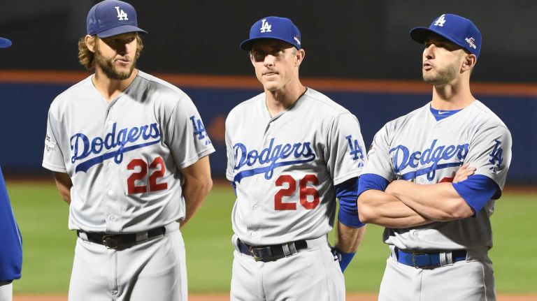 Los Angeles Dodgers starting pitcher Clayton Kershaw (22), second baseman Chase Utley (26) and centerfielder Justin Ruggiano (27) look on during player introductions before Game 3 of the NLDS against the New York Mets on Monday, Oct. 12, 2015.