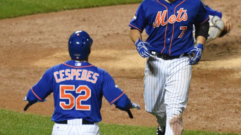 New York Mets center fielder Yoenis Cespedes (52) waits at home as New York Mets catcher Travis d'Arnaud (7) is all smiles after a two-run homer in the 3rd inning as the Mets vs. Dodgers at Citi Field in Queens during Game 3 of the NLDS on Monday, Oct. 12, 2015.