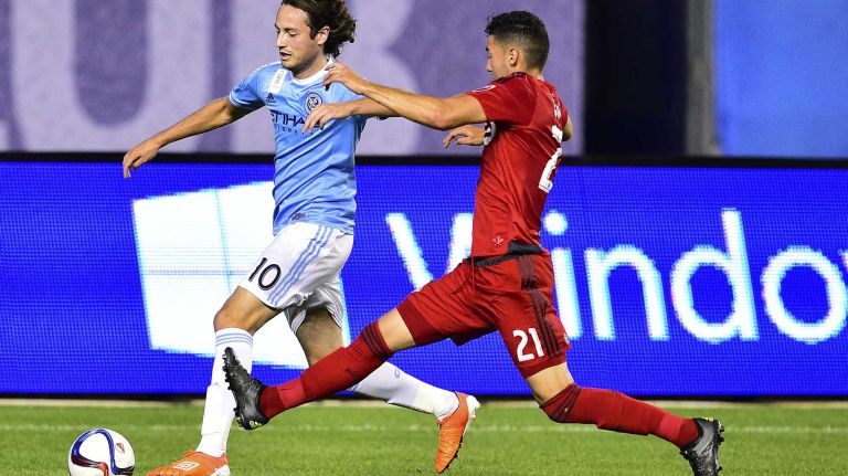 New York City FC midfielder Mix Diskerud is defended by Toronto FC midfielder Jonathan Osorio in an MLS game at Yankee Stadium on Wednesday, Sept. 16, 2015.