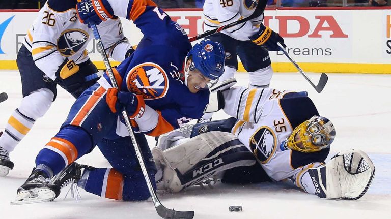 Anders Lee #27 of the New York Islanders attempts to control the puck in front oif Linus Ullmark #35 of the Buffalo Sabres during the second period at the Barclays Center on November 1, 2015.