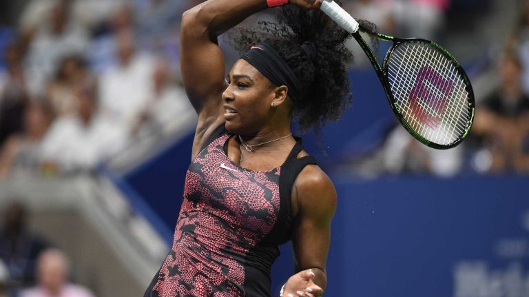Serena Williams returns to Venus Williams during the women's singles quarterfinals at the U.S. Open tennis tournament on Tuesday, Sept. 8, 2015.