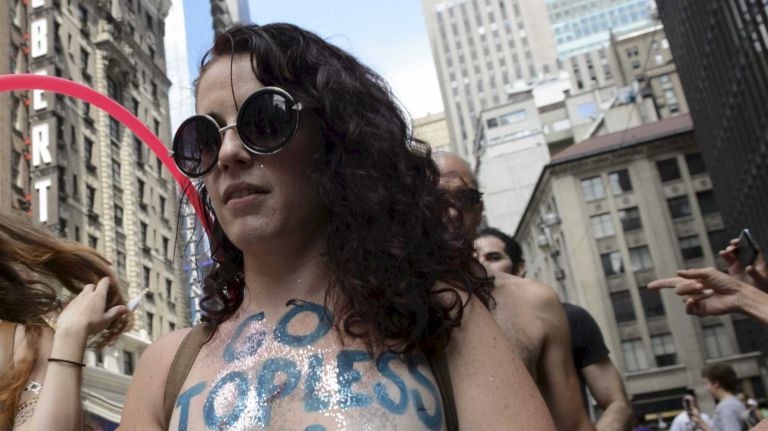 Participants, some topless, march in midtown Manhattan during an event marking International Go Topless Day on Sunday, August 23, 2015. The event was independent of, but coincide with, the apparent proliferation topless tip seeking women in Times Square.
