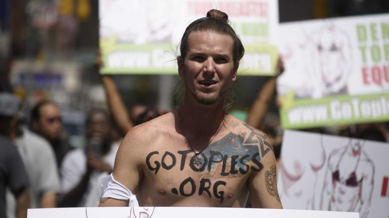Participants, some topless, march in midtownManhattan during an event marking International Go Topless Day on Sunday, August 23, 2015. The event was independent of, but coincide with, the apparent proliferation topless tip seeking women in Times Square.