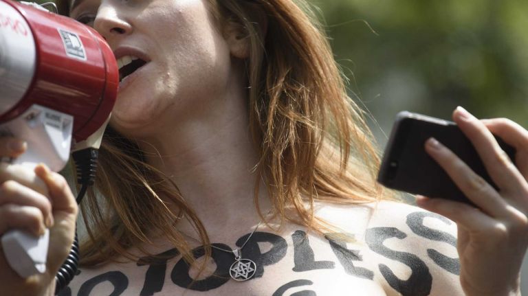 Rachel Jessee speaks during a rally in Bryant Park during an event marking International Go Topless Day in Manhattan on Sunday, August 23, 2015. The event was independent of, but coincide with, the apparent proliferation topless tip seeking women in Times Square.
