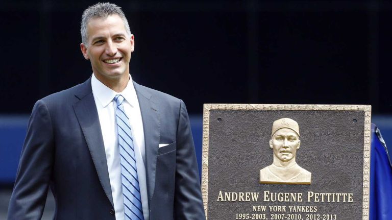 Andy Pettitte stands next to his Monument Park plaque during a ceremont before a game between the New York Yankees and the Cleveland Indians at Yankee Stadium on Sunday, Aug. 23, 2015.