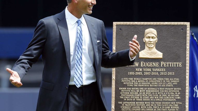 Andy Pettitte stands next to his Monument Park plaque during a ceremony before a game between the New York Yankees and the Cleveland Indians at Yankee Stadium on Sunday, Aug. 23, 2015.
