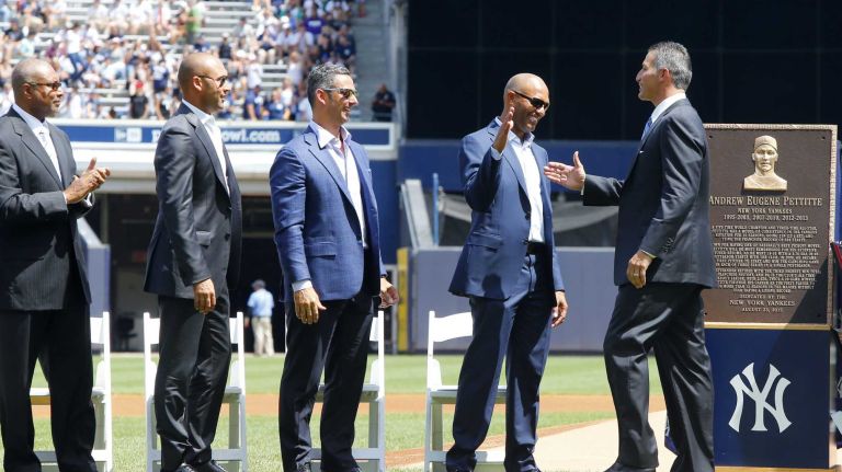 Andy Pettitte is congratulated after a pregame ceremony by former teammates, from left, Bernie Williams, Derek Jeter, Jorge Posada and Mariano Rivera before the Yankees play against the Cleveland Indians at Yankee Stadium on Sunday, Aug. 23, 2015.