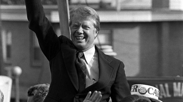 Jimmy Carter and his wife Rosalynn waving to the crowd at the Schuetzen Park in North Bergen City on October 23, 1976 . 
