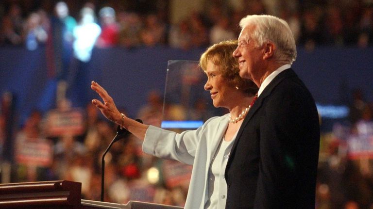 Jimmy Carter and wife Rosalynn wave to delegates after his address on the opening night of the Democratic National Convention on July 26, 2004.