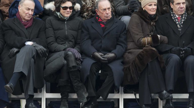 From left seated in the front row: Senator Charles Schumer, Diana Taylor, Former Mayor Michael Bloomberg, Sandra Lee, and Governor Andrew Cuomo on the dais before President Bill Clinton administers the oath of office to new Mayor Bill de Blasio outside of City Hall on Wednesday in Manhattan. (Jan. 01, 2014).