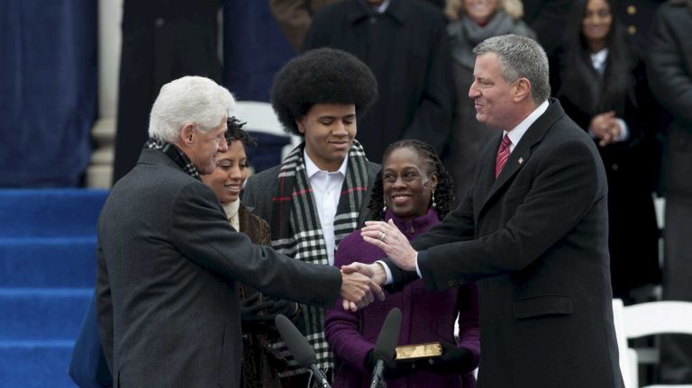 Former President Bill Clinton shakes hands with Mayor Bill de Blasio after administering the oath of office during a ceremony outside of City Hall on Wednesday in Manhattan. (January 01, 2014).