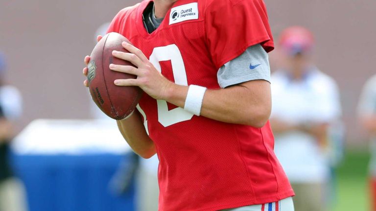 New York Giants quarterback Eli Manning drops back to pass during training camp at the Quest Diagnostics Training Center in East Rutherford, N.J., on Saturday, Aug. 8, 2015.
