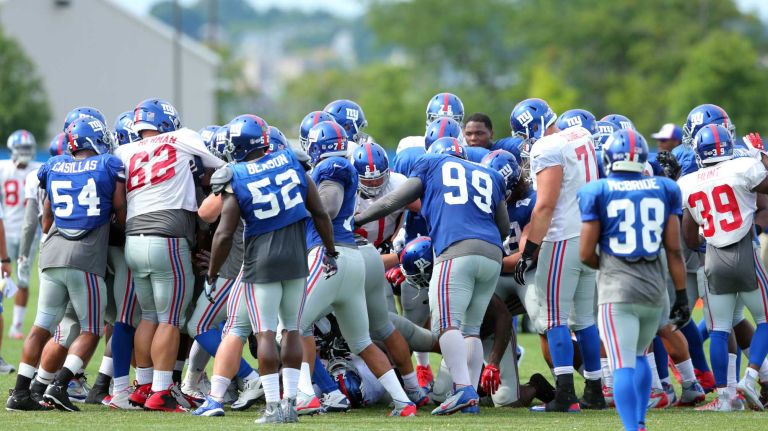 A fight breaks out between the offense and defense during New York Giants training camp at the Quest Diagnostics Training Center in East Rutherford, N.J., on Saturday, Aug. 8, 2015.