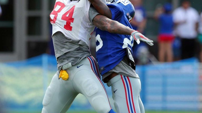 New York Giants tight end Larry Donnell misses a pass while defended by safety Jeromy Miles during training camp at the Quest Diagnostics Training Center in East Rutherford, N.J., on Saturday, Aug. 8, 2015.