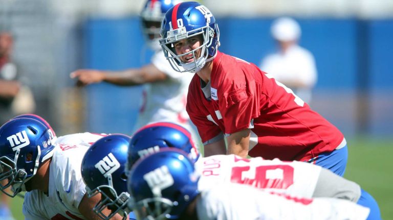 New York Giants quarterback Eli Manning lines up behind center during training camp at the Quest Diagnostics Training Center in East Rutherford, N.J. on Friday, Aug. 7, 2015.