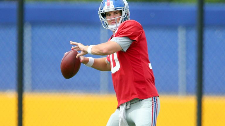 New York Giants quarterback Eli Manning drops back to pass during training camp at the Quest Diagnostics Training Center in East Rutherford, N.J., on Saturday, Aug. 8, 2015.