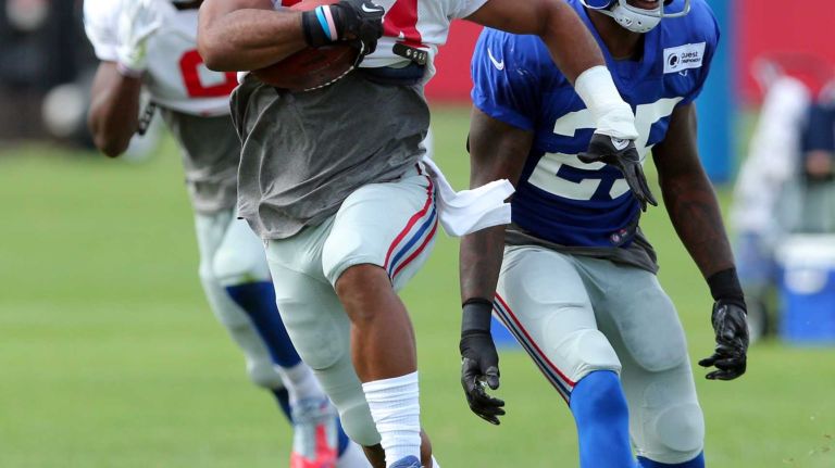 New York Giants running back Shane Vereen runs with the ball past safety Jeromy Miles during training camp at the Quest Diagnostics Training Center in East Rutherford, N.J., on Saturday, Aug. 8, 2015.