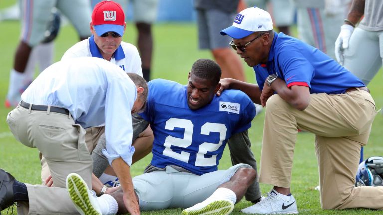 New York Giants corner back Chykie Brown is tended to after injuring his right knee during training camp at the Quest Diagnostics Training Center in East Rutherford, N.J., on Saturday, Aug. 8, 2015.