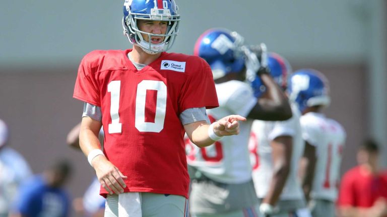 New York Giants quarterback Eli Manning gestures at the line during training camp at the Quest Diagnostics Training Center in East Rutherford, N.J. on Thursday, Aug. 6, 2015.