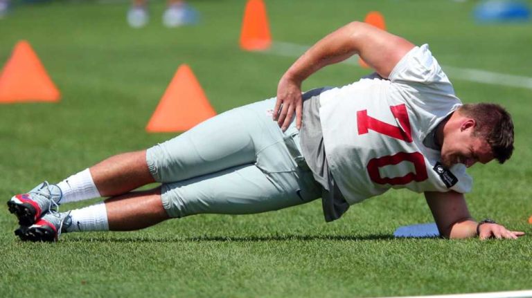 New York Giants guard Weston Richburg stretches during training camp at the Quest Diagnostics Training Center in East Rutherford, N.J., on Wednesday, Aug. 5, 2015.