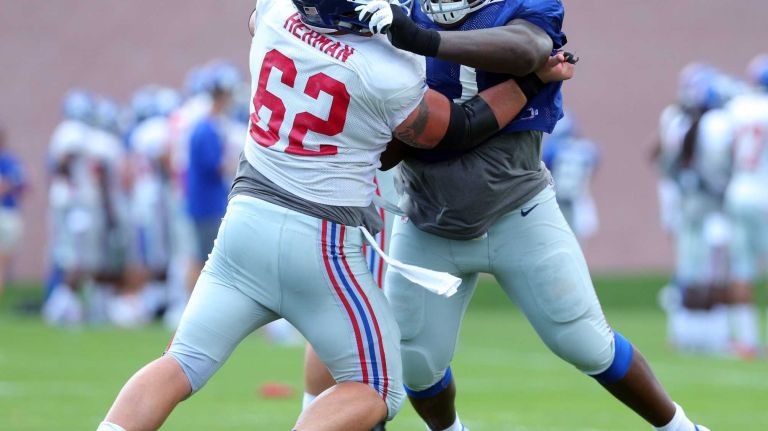New York Giants defensive tackle Kenrick Ellis works on guard Eric Herman during training camp at the Quest Diagnostics Training Center in East Rutherford, N.J., on Wednesday, Aug. 5, 2015.