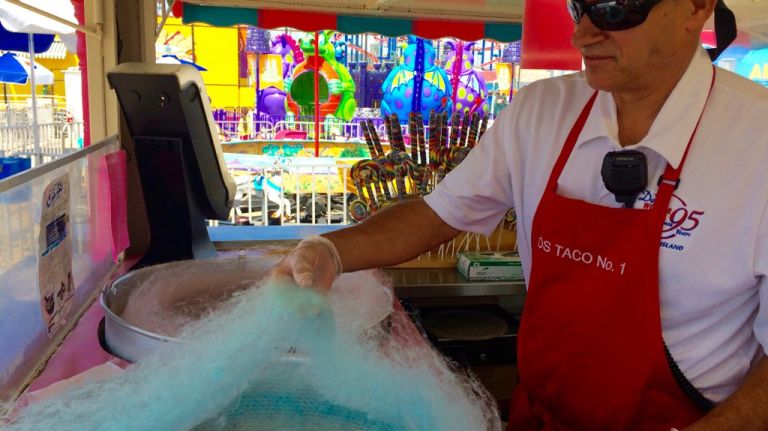 Dennis Vourderis, one of the brothers who co-own Deno's Wonder Wheel Park, makes cotton candy at the sweet shop at the kiddie park on July 17, 2015. He calls it his favorite place to work. 
