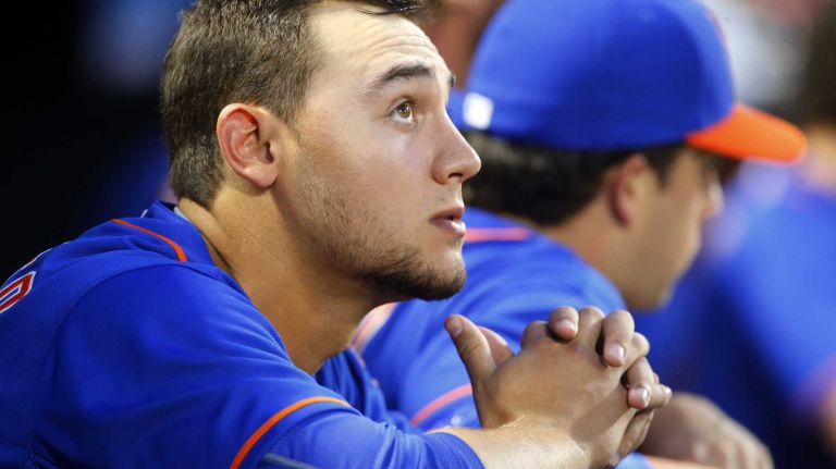 Michael Conforto of the Mets looks on from the dugout against the Los Angeles Dodgers at Citi Field on Friday, July 24, 2015.