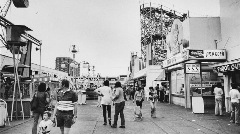 Visitors sample the attractions along the midway at Rockaways' Playland on July 29, 1977.