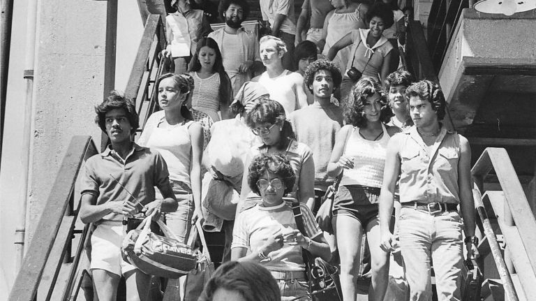 People leave the elevated train at Beach 98th Street, the Rockaways' Playland exit, and head for the beach on June 25, 1978.