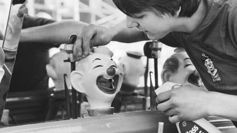 John Miller, of Rockaway Park, Queens, polishes up clown face at Rockaways' Playland at the pre-grand opening on May 16, 1984.