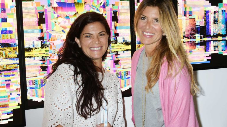 Frances Sinkowitz and Gloria Porcella blend into the city scene at Art Southampton at Nova's Ark on July 10, 2015 in Water Mill.