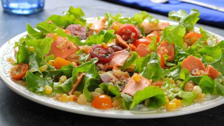 <b>WHAT YOU'LL NEED</b>:<br> 1/2 cup quinoa<br> 4 (4-ounce) pieces salmon fillet<br> 3/4 teaspoon salt, divided<br> 1/8 teaspoon black pepper<br> 3 tablespoons extra-virgin olive oil, divided<br> 1/2 teaspoon Dijon mustard<br> 1 tablespoon red wine vinegar<br> Kernels from 2 ears corn (about 1 cup)<br> 12 cups green oak, butter or any other lettuce<br> 1 pint cherry tomatoes (any color), halved<br><br> <b>HOW TO</b>:<br><br> 1. Cook quinoa according to package instructions.<br><br> 2. Season the salmon with 1/2teaspoon of the salt and the black pepper. Heat 1 tablespoon of the oil in a large, nonstick skillet over medium high. Add the salmon and cook 3 to 4 minutes on each side, or until fish is cooked to desired degree of doneness. Transfer to a plate and allow to cool slightly.<br><br> 3. Combine the Dijon and vinegar in a bowl; whisk in the remaining 2 tablespoons olive oil and 1/4 teaspoon salt. Toss the dressing with the corn, lettuce, tomatoes and quinoa. Separate the salmon into flakes and gently toss it into the salad. Makes 4 servings.