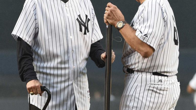 Former New York Yankees Joe Torre, right, presents former Yankees pitcher and pitching coach Mel Stottlemyre a Monument Park plaque replica during the 69th Old-Timers' Day at Yankee Stadium before a baseball game between the Yankees and the Detroit Tigers on Saturday, June 20, 2015.
