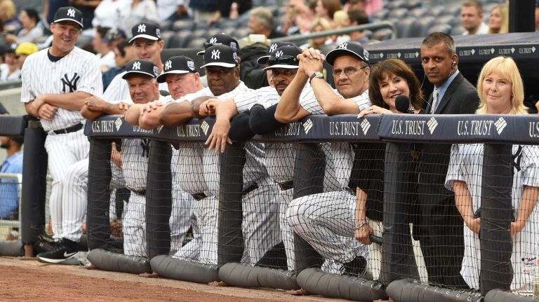 Former New York Yankees players watch from the dugout as Willie Randolph speaks to the crowd during the 69th Old-Timers' Day at Yankee Stadium before a baseball game between the Yankees and the Detroit Tigers on Saturday, June 20, 2015.