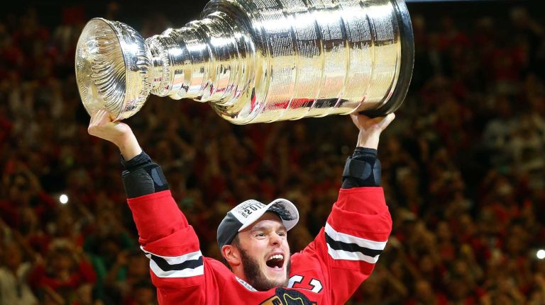 Stanley Cup Final: Blackhawks vs. Lightning 25 Jonathan Toews #19 of the Chicago Blackhawks celebrates by hoisting the Stanley Cup after defeating the Tampa Bay Lightning, 2-0, in Game 6 to win the 2015 NHL Stanley Cup Final at the United Center on June 15, 2015 in Chicago.