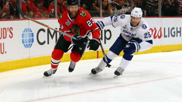 Stanley Cup Final: Blackhawks vs. Lightning 36 CHICAGO, IL - JUNE 15: Kris Versteeg #23 of the Chicago Blackhawks fights for the puck against Matt Carle #25 of the Tampa Bay Lightning in the first period of Game Six of the 2015 NHL Stanley Cup Final at the United Center on June 15, 2015 in Chicago, Illinois. (Photo by Bruce Bennett/Getty Images)