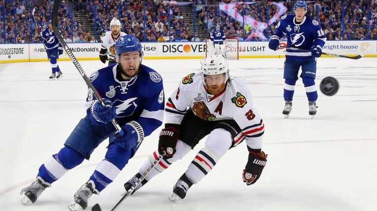 Stanley Cup Final: Blackhawks vs. Lightning 41 TAMPA, FL - JUNE 13: Tyler Johnson #9 of the Tampa Bay Lightning fights for the puck against Duncan Keith #2 of the Chicago Blackhawks during Game Five of the 2015 NHL Stanley Cup Final at Amalie Arena on June 13, 2015 in Tampa, Florida. (Photo by Bruce Bennett/Getty Images)