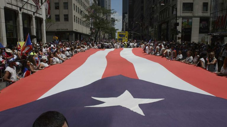 Participants march along 5th Avenue during the 58th annual Puerto Rican Day Parade in Manhattan on June 14, 2015. The annual parade celebrates Puerto Rican heritage and culture. It is one of the largest parades in New York City.