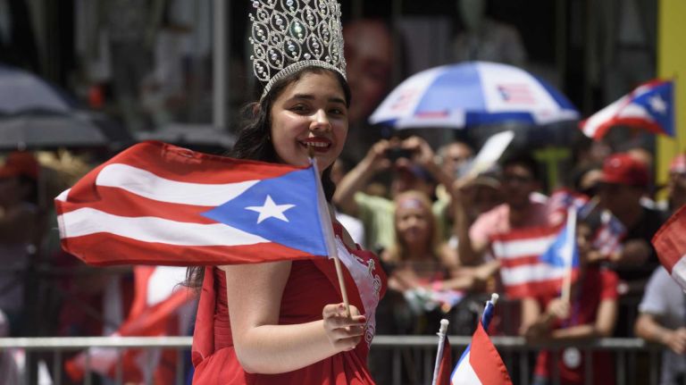 A participant is driven along 5th Avenue during the 58th annual Puerto Rican Day Parade in Manhattan on June 14, 2015. The annual parade celebrates Puerto Rican heritage and culture. It is one of the largest parades in New York City.