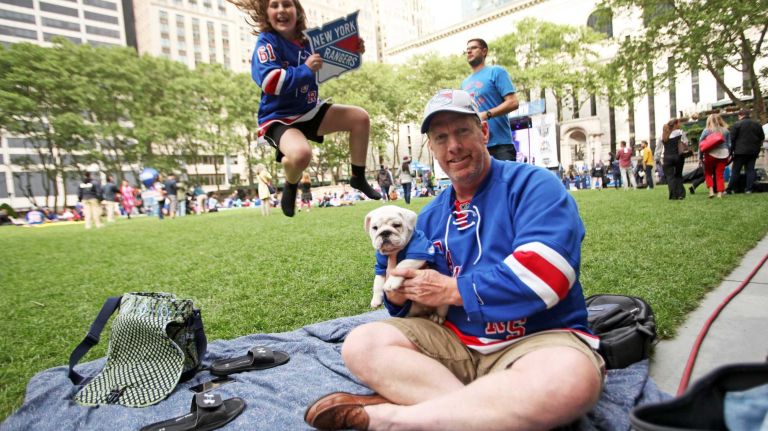 Rangers viewing party in Bryant Park 12 Ava LaBelle, 11 of Huntington, her dad Brendan LaBelle and dog Shiro enjoy the free Rangers' outdoor viewing party in Bryant Park in Manhattan on Wednesday, May 20, 2015.