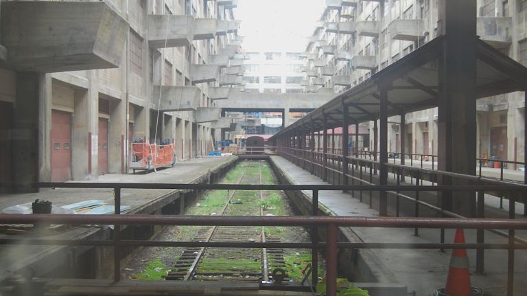 Railroad tracks used to run between the two sides of Industry City. Cranes would take cargo from each floor and load the trains up with goods. 