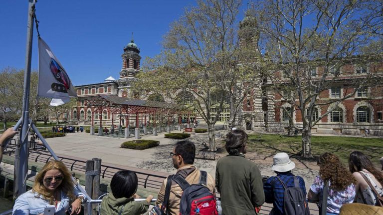 Visitors stand on a Statue Cruises ferry looking out at Ellis Island May 7, 2015. 